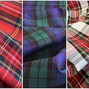 May include: Three different plaid fabrics, one red, one blue and green, and one white and red.