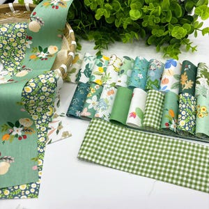 May include: An assortment of patterned fabric rolls in shades of green, white, and floral designs. The fabrics feature floral, gingham, and botanical prints, ideal for crafts and sewing. The image displays a variety of fabric patterns.
