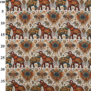 May include: A fabric pattern featuring repeating illustrations of elephants adorned in ornate, colorful decorative gear, interspersed with intricate circular medallions and small elephant motifs, set against a light background with a 35 cm metric ruler.