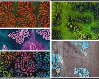 May include: A collage of five different fabric swatches with batik designs. The swatches feature a variety of colors and patterns, including orange, green, blue, pink, and black. The designs include paisley, butterflies, and elephants.