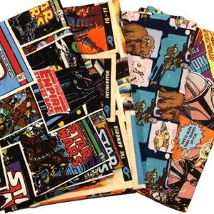 May include: A collection of Star Wars-themed fabric pieces. The fabric features comic book-style panels with characters and text like "STAR WARS", "EMPIRE STRIKES BACK", and "THE ARMORER". Colors include blue, red, orange, and black.