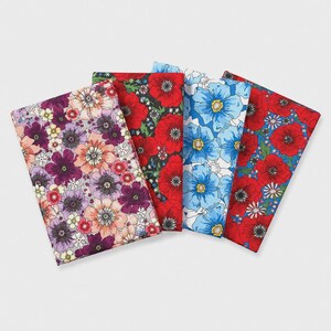 May include: Four rectangular fabric swatches arranged in a fan shape. The first features purple and peach flowers on a light background. The second shows red poppies on black. The third displays blue flowers on white. The fourth has red poppies on blue.