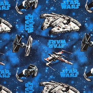 May include: Blue fabric with a repeating pattern of Star Wars spaceships and the text "Star Wars". The spaceships include the Millennium Falcon, X-Wing, and TIE fighter.