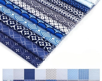 May include: A stack of 12 blue and white patterned fabric squares. The fabric features geometric designs, including circles, squares, and waves.
