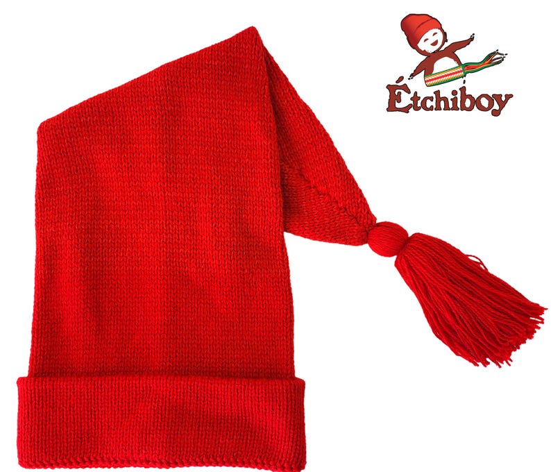 May include: Red knitted sleeping cap with a long tassel. The cap has a fold-over brim.