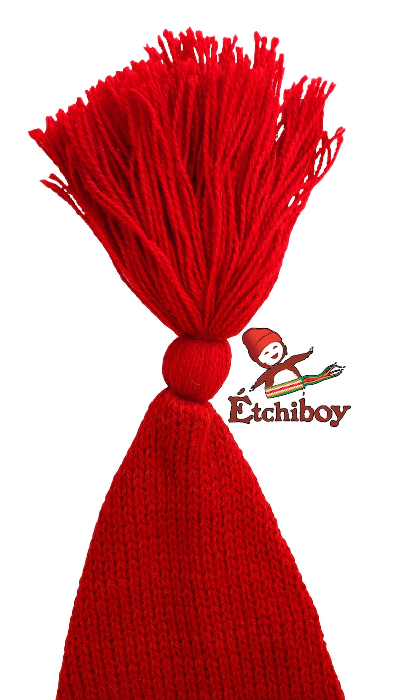 May include: A red knitted hat with a large red tassel. The hat is made of a soft, warm material and is perfect for keeping your head warm in the winter.
