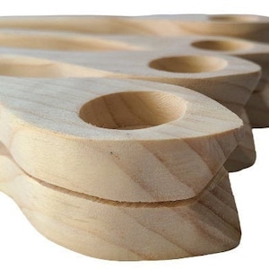 Könnte beinhalten: Satz mit vier Holzlöffeln mit einem einzigartigen, geschwungenen Design. Die Löffel sind aus Naturholz gefertigt und haben eine glatte Oberfläche.