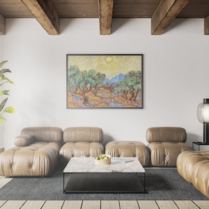 May include: A living room interior with a brown leather sectional sofa, a coffee table, a potted plant, and a framed painting of a landscape with olive trees. The painting is in a style reminiscent of Vincent van Gogh.