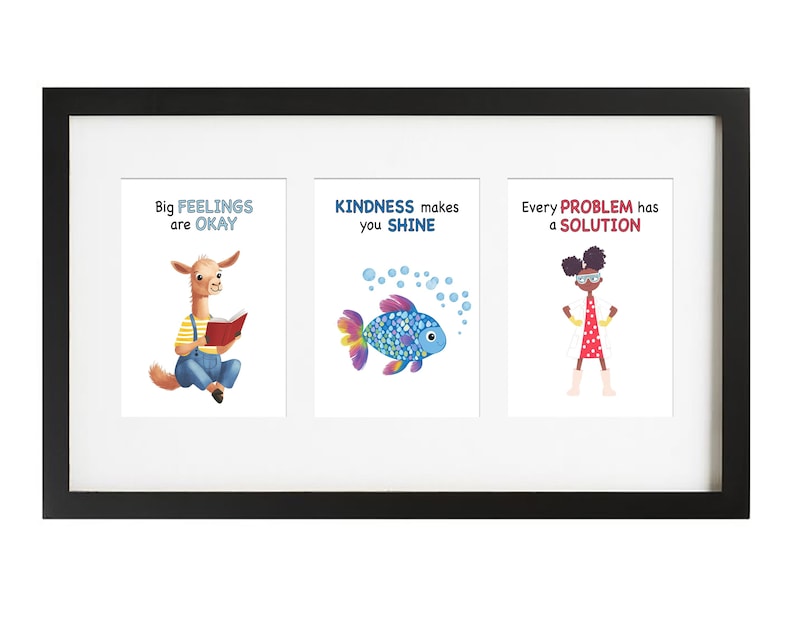 May include: A black framed print with three colorful illustrations. The first illustration features a llama reading a book with the text "Big Feelings are Okay". The second illustration features a blue and pink fish with the text "Kindness makes you Shine". The third illustration features a girl with glasses and a red dress with the text "Every Problem has a Solution".