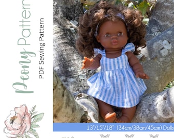 May include: A sewing pattern for a Banksia Doll dress in three sizes: 13 inches, 15 inches, and 18 inches. The pattern includes a line drawing of the dress with a ruffled hem and straps. The pattern is for dolls with a chest measurement of 34 cm, 38 cm, or 45 cm.