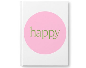 May include: A white notebook with a pink circle and the word "happy" in green text.