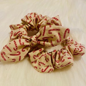 Handmade Christmas scrunchies. White with red candy canes.