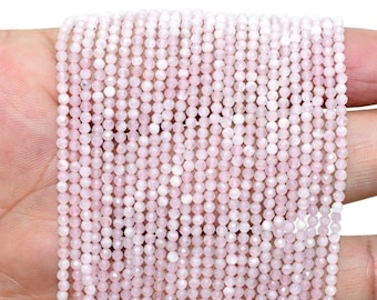 May include: A strand of pale pink gemstone beads, likely rose quartz, with a faceted finish. The beads are small and uniform in size, creating a delicate and elegant look.