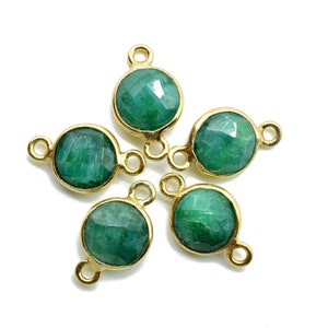 May include: Five gold-toned connector charms with green gemstone cabochons. Each charm has two loops for attaching to jewelry.