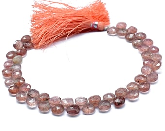 May include: A strand of faceted, pink and clear gemstone beads with a tassel.