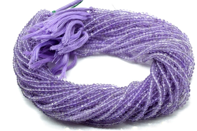 May include: A strand of light purple amethyst beads, approximately 4mm in size, with a purple tassel.