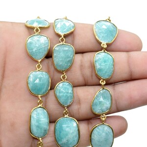 May include: A strand of light blue gemstone beads with gold accents. The beads are oval shaped and have a faceted finish. The strand is approximately 18 inches long.