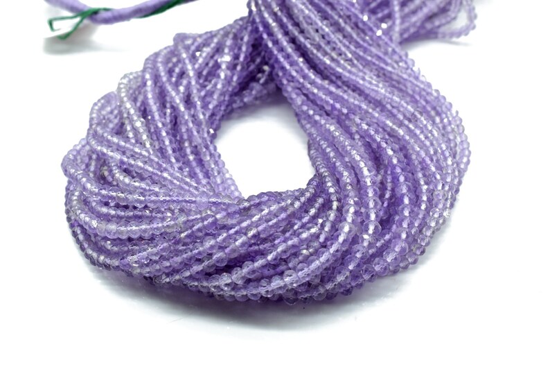 May include: A strand of light purple amethyst beads. The beads are faceted and have a slightly irregular shape. The strand is approximately 16 inches long.