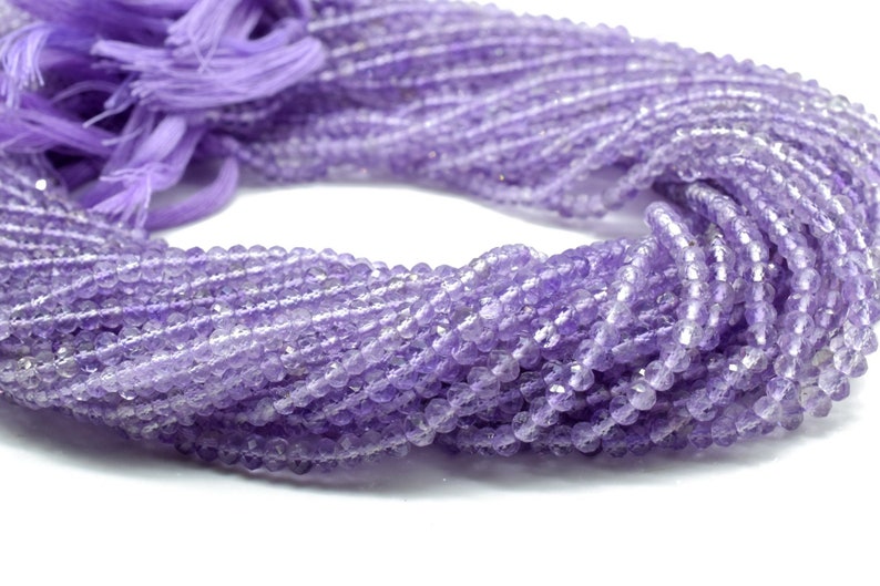 May include: A strand of light purple amethyst beads. The beads are faceted and have a slightly irregular shape. The strand is approximately 16 inches long.