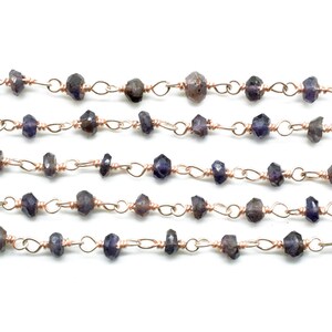 May include: A strand of faceted amethyst beads strung on a copper wire chain. The beads are a deep purple color and are approximately 4mm in size.
