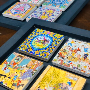 May include: A set of six decorative tiles with intricate designs. The tiles feature a variety of colors, including blue, yellow, red, green, and white. The tiles are arranged in a frame, and the designs are inspired by traditional Persian art.