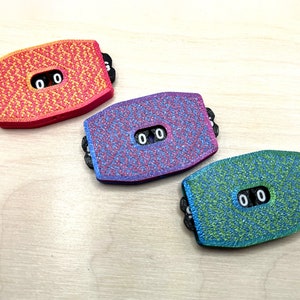 May include: Three colorful counter pieces with a textured surface and a black display showing "00".