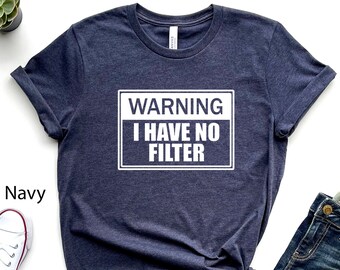 May include: A heather navy blue t-shirt with a white graphic that says "WARNING I HAVE NO FILTER" in a white rectangle.