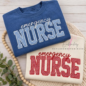 May include: A blue sweatshirt and a cream sweatshirt, each featuring the text "emergency NURSE" embroidered in a gingham pattern. The blue sweatshirt has blue and white gingham lettering, while the cream sweatshirt has red and white gingham lettering.