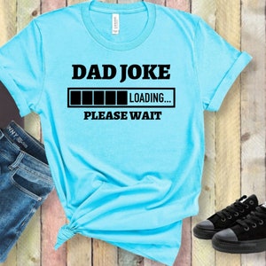 May include: A light blue t-shirt with a black graphic that says "Dad Joke" and a progress bar that says "Loading... Please Wait."