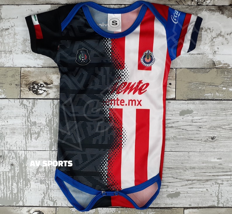 May include: A white, red, and black baby onesie with a team logo and the words "Chivas" and "Chivas.mx".