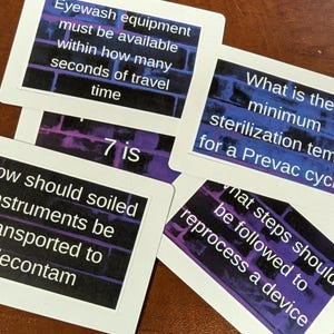 May include: Cards with questions and answers related to medical procedures. The cards have white borders and black text on a purple and blue background. Questions include: "Eyewash equipment must be available within how many seconds of travel time?"