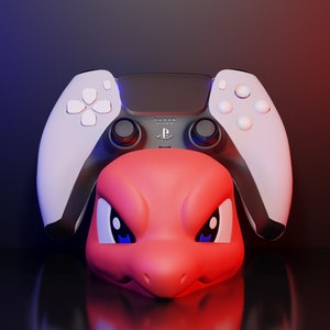 May include: A white and black PlayStation 5 controller with red and blue accents. The controller is positioned on top of a red, cartoon-style bird head.