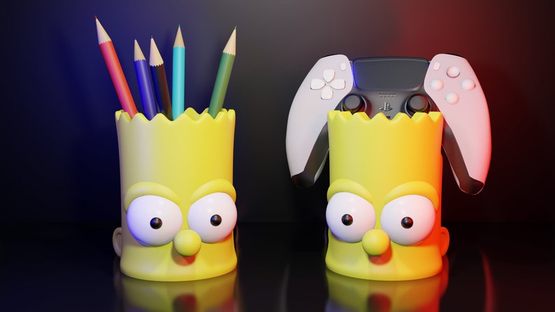 May include: Two yellow Simpsons character pencil holders. One holder has a set of colored pencils inside. The other holder has a white and black video game controller on top.