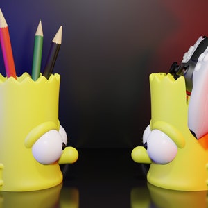 May include: Two yellow cartoon character pencil holders. One holder has five colored pencils inside. The other holder has a white and black video game controller inside.