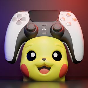 May include: A yellow Pikachu-shaped controller stand featuring a smiling face with red cheeks, supporting a white and black wireless game controller with a central PlayStation logo and dual analogue sticks, set against a dark gradient background.