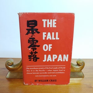 May include: A red hardcover book titled "The Fall of Japan" with Japanese characters on the cover. The book is about the final weeks of World War II in the Pacific and includes photographs and maps. The book is by William Craig.