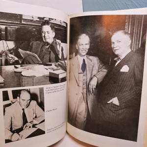 May include: Black and white photograph of three men in suits, one seated at a desk. The image is from a book, with text visible, including "Alvin J. (Senator)" and "Charles Marsh."