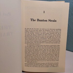 May include: Open book page with text titled "The Bunton Strain" and the number "1" at the top. The text describes a family's history and characteristics, including physical traits and personality.