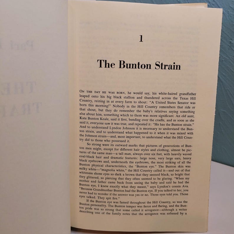 May include: Open book page with text titled "The Bunton Strain" and the number "1" at the top. The text describes a family's history and characteristics, including physical traits and personality.