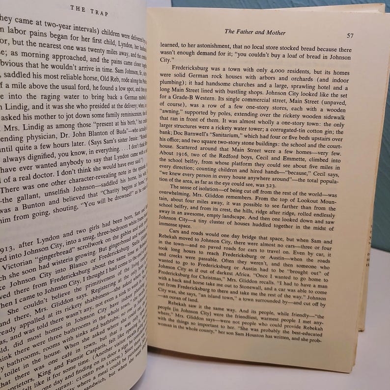 May include: Open book pages with text, featuring the title "The Trap" and "The Father and Mother." The text is in black font on aged, yellowed paper. The pages are slightly curled, suggesting age and use. The book is open to a double-page spread.