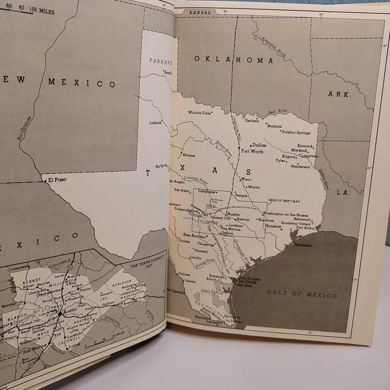 May include: Open book with detailed black and white maps of the southwestern United States, including Texas, New Mexico, and Oklahoma. The maps show cities, rivers, and geographical features. The text includes the names of states and cities.