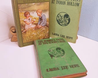 May include: Three vintage books with green covers. The titles include "The Bobbsey Twins Keeping House", "The Bobbsey Twins at Indian Hollow", and "The Bobbsey Twins at the County Fair". The books feature illustrations and text by Laura Lee Hope.