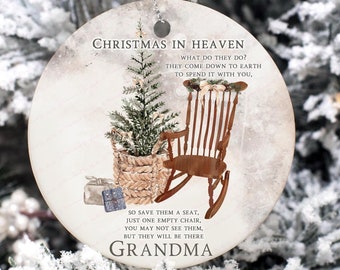 May include: A white round Christmas ornament with a brown rocking chair, a small pine tree in a basket, and the text "Christmas in Heaven. What do they do? They come down to earth to spend it with you. So save them a mat, just one empty chair. You may not see them, but they will be there. Grandma."