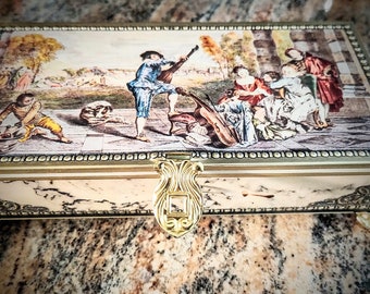 Jamin Dutch candy tin, West German made hinged box with painting "The attractions of life" . Free shipping in the continental United States.