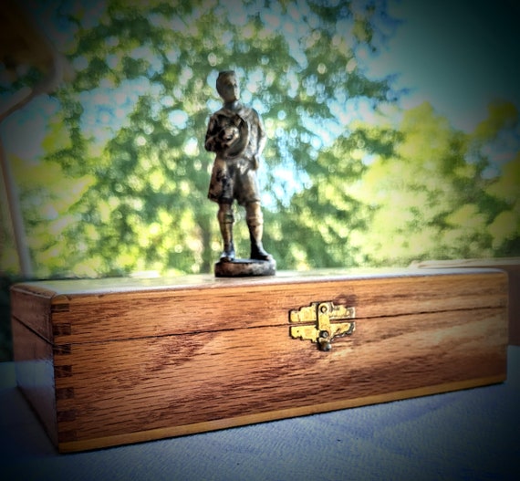 R. Tait McKenzie statue of Boy Scout on wood box.… - image 1