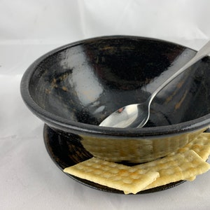 Medium soup and crackers bowl, glossy black and rust.  Base has a lip to hold crackers, all one piece.
