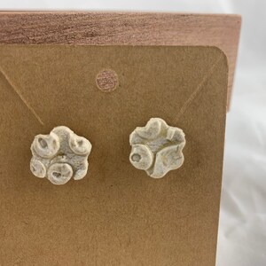 Earrings, flower cut out, floral imprint. Butter yellow/cream. Hypo-allergenic stud backs. 1/2” across.