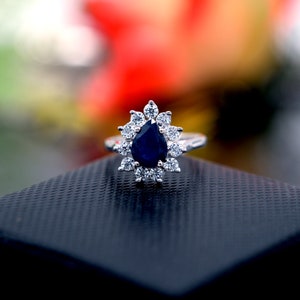 Pear Cut Blue Sapphire Sterling Silver Ring: White Topaz Halo