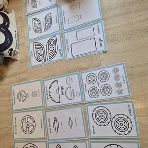 May include: Flashcards illustrating car parts such as headlights, number plates, steering wheels, speedometers, door handles, and wheels. Each card is labelled with a size: very small, small, medium, and large.