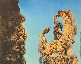 May include: Surrealist painting featuring organic forms in shades of brown, tan, and yellow against a light blue sky. The artwork has a textured appearance, with the artist's signature in the lower right corner. The painting evokes a dreamlike landscape.